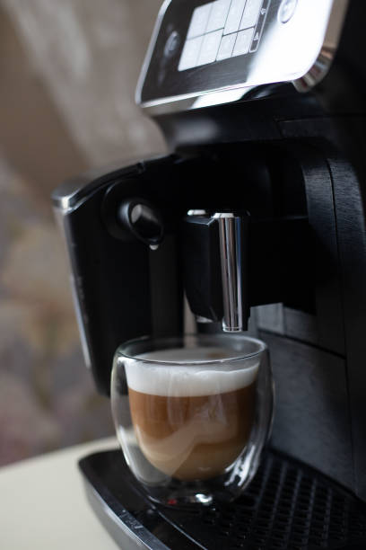 istock The coffee machine prepares coffee in a transparent glass mug 1368967343