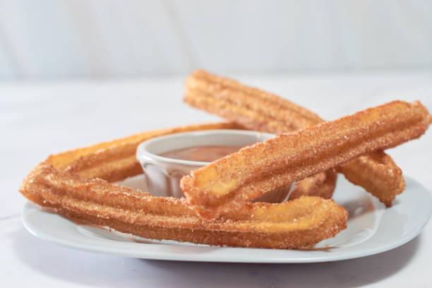 istock Mexican churros served on a homemade plate. 1368967589