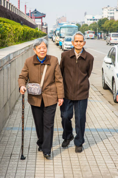 istock Senior Man and Woman Walking Outside. 1368969800