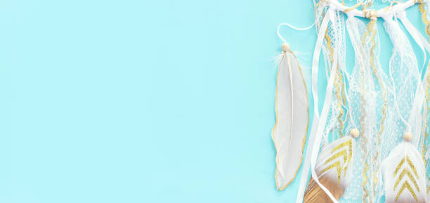 istock Image of white dream catcher over pastel blue background. Top view 1368969973