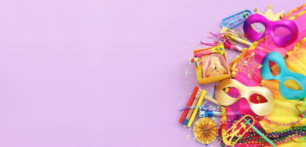 istock Purim celebration concept (jewish carnival holiday) over purple wooden background 1368970026