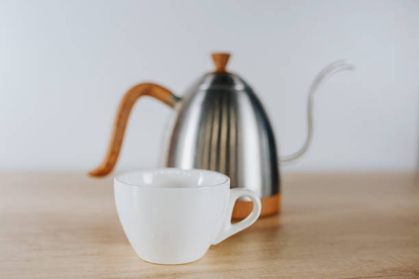 istock Coffee metal teapot and white cup in the foreground 1368972322