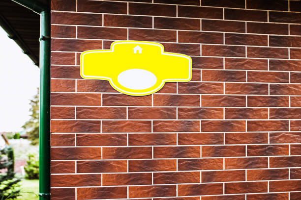 istock Sample yellow house number plaque on a brick wall 1368973713