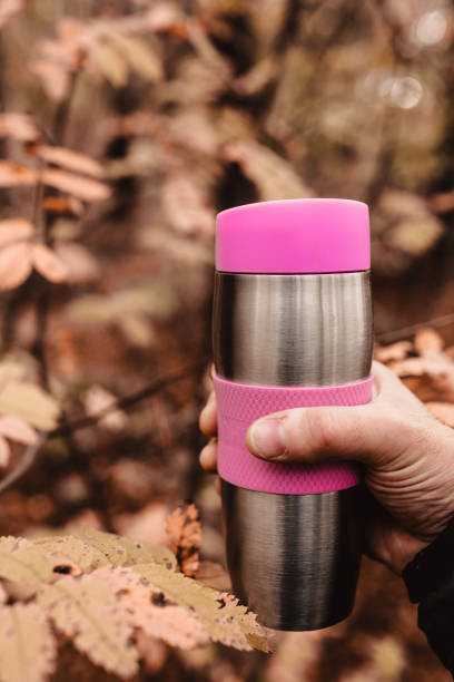 istock A man hand with a metal thermos in his hand 1368974252