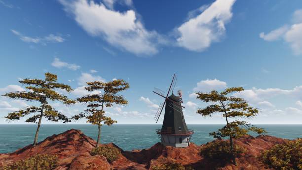 Wooden windmill between trees with ocean in the background