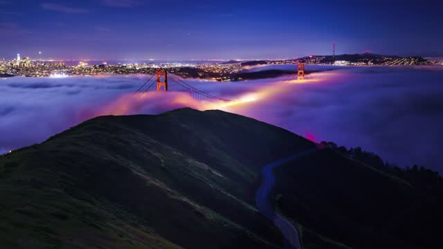 Golden Gate Bridge with flowing fog timelapse at night