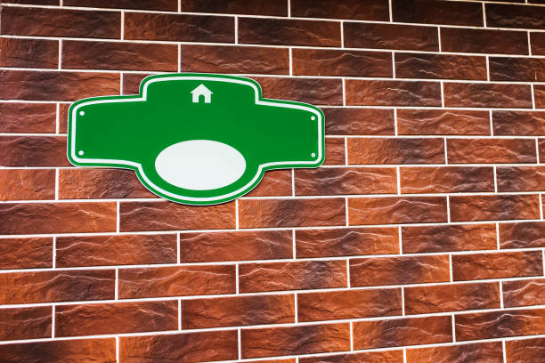 istock Green plaque for house number on a brick wall 1368975442
