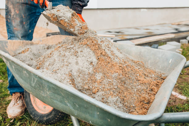 istock A worker mixes cement with sand directly in a construction wheelbarrow 1368975468