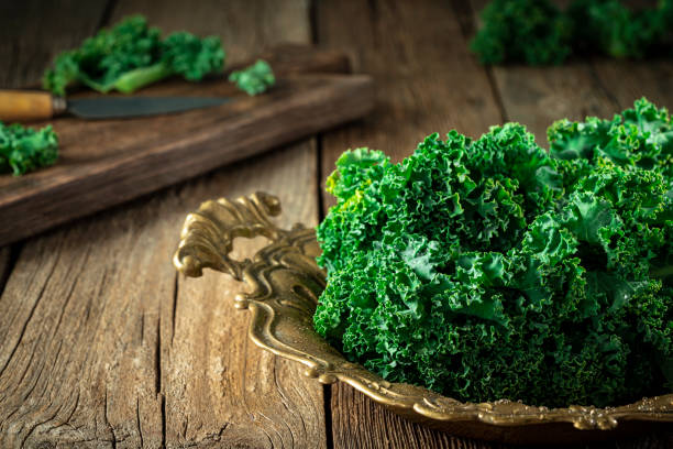 Kale crucifer leaf vegetable on rustic wood board table curly kale