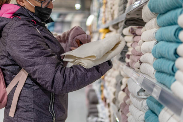 istock Woman in a store chooses textiles. 1368976964