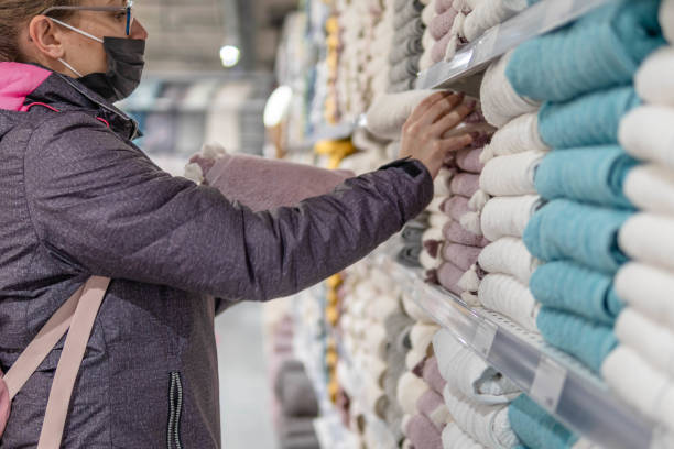 istock Woman in a store chooses textiles. 1368976982