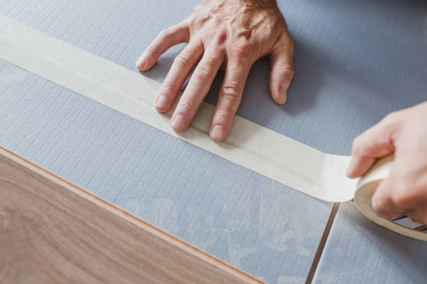 istock The master connects the foam polystyrene backing plates with adhesive tape before laying the laminate 1368977204