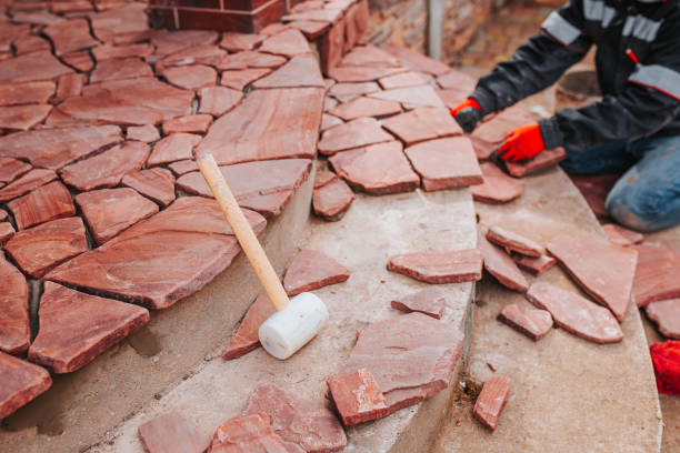 Stone mosaic for facing the terrace of the house Stone mosaic for facing the terrace of the house - laying the tiles outside - professional work of the tiler mason craftsperson stock pictures, royalty-free photos & images