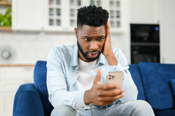 istock Upset brunette young man holding smartphone, looking with disappointment face expression at phone screen, received a bad comment in social networks from hater, dislike 1368977432