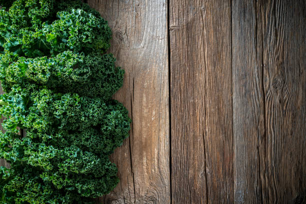 istock Kale crucifer leaf vegetable on rustic wood board curly kale copy space 1368977464