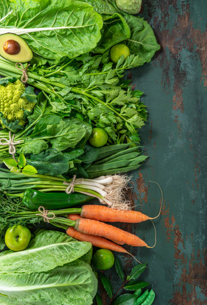 istock Fruits and vegetables assorted on green wooden background leaving copy space 1368977772