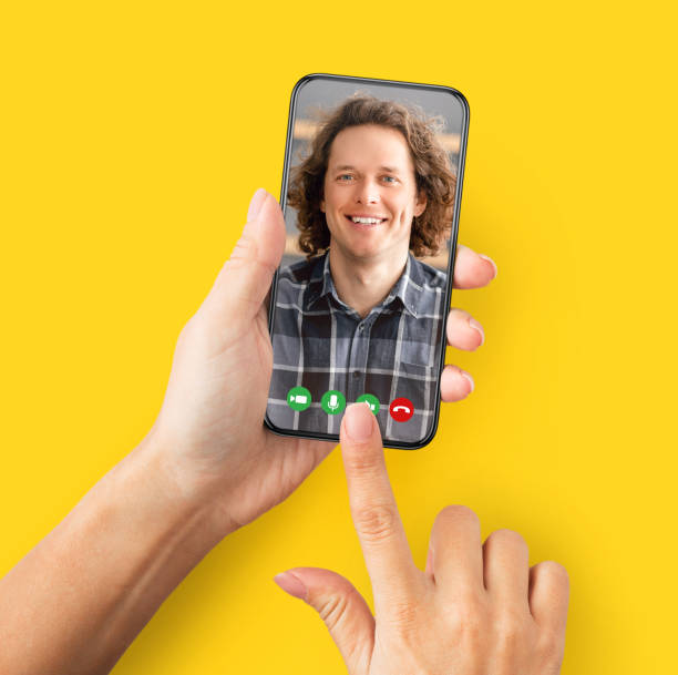 istock Young female holding cellphone in hand video calling friend 1368978656