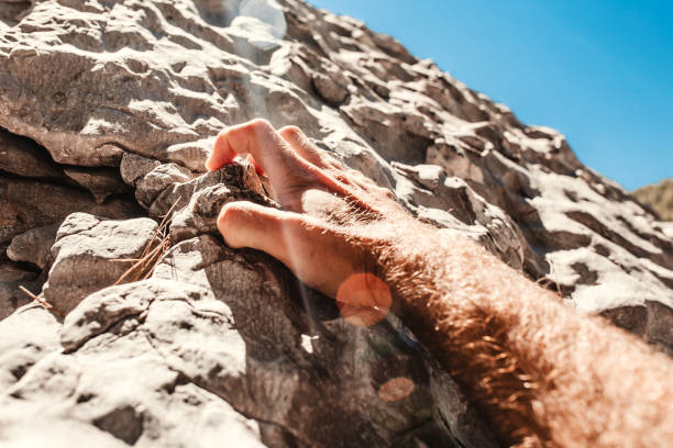 istock Difficult hard ascent upward - a male hand 1368978765