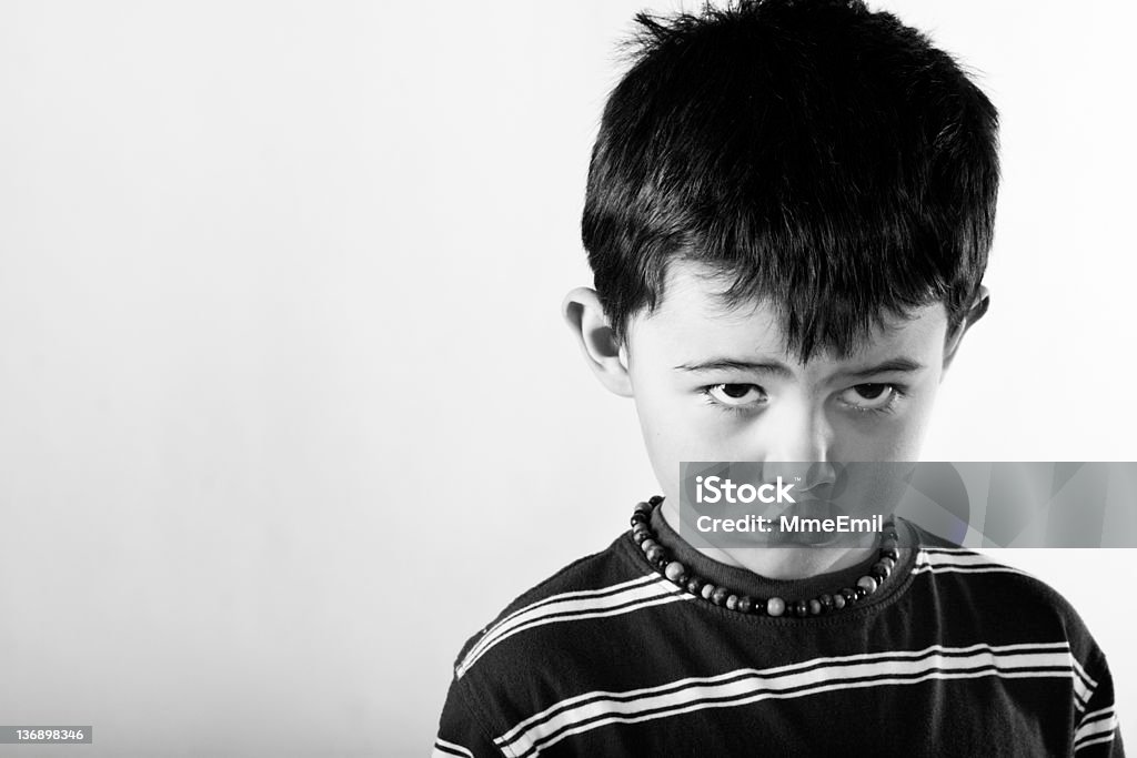 Scolding kiddo Little punish boy, wanting to be forgive... how can you resist to those beautiful eyes... Black And White Stock Photo
