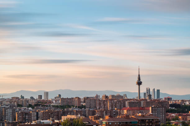Skyline of Madrid at dusk as seen from Cerro del Tio Pio, with the TV Tower and the skyscrapers along Castellana to be recognised. Long exposure.