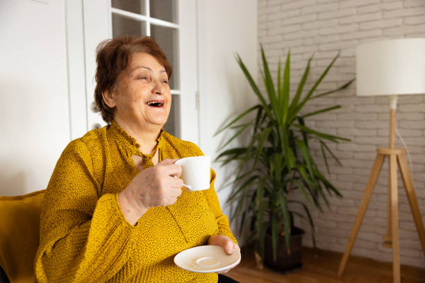 istock Senior woman drinking coffee at home 1368988742