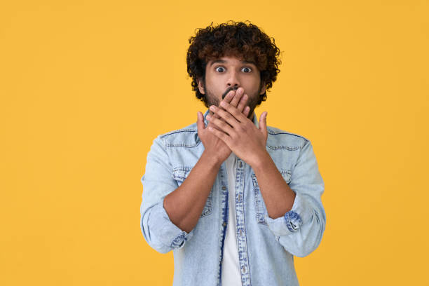 istock Shocked surprised young indian man isolated on yellow background. 1368989991