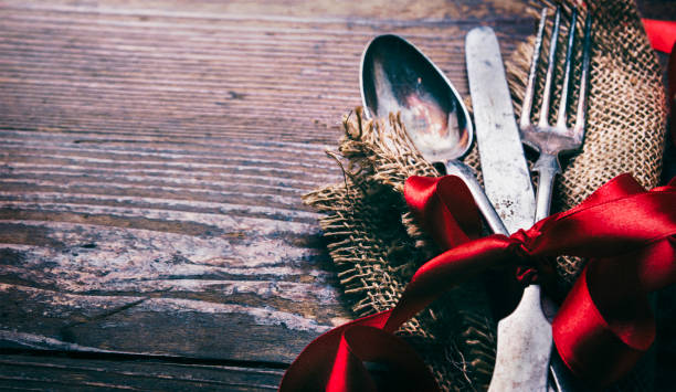 istock Valentine day dine. Valentines dinner background with vintage silverware and red ribbon on wooden table. Luxury restaurant menu for romantic celebration event. 1368990940