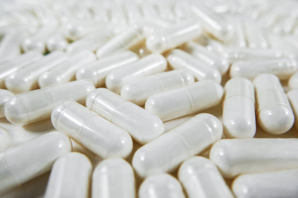 comprimidos - painkiller vitamin pill full frame macro - fotografias e filmes do acervo