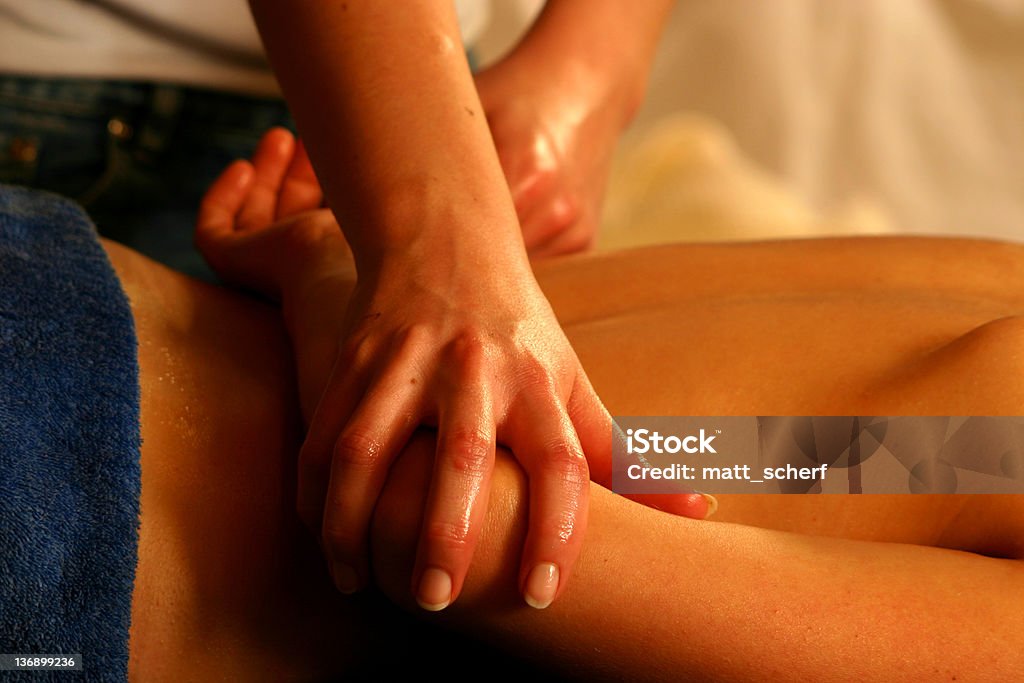 Moving the Arm A massage therapist moves an arm into position for a maniplulation Alternative Therapy Stock Photo