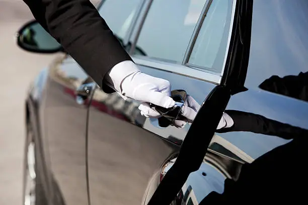 Photo of Chauffeur opening / closing luxury car door