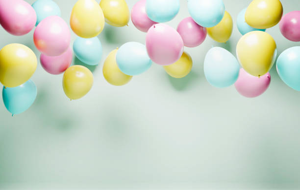 Colorful helium balloons on retro pastel background. Birthday celebration and baby shower decor. Minimal creative idea for party event decor. "nColorful helium balloons on retro pastel background. Birthday celebration and baby shower decor. Minimal creative idea for party event decor. hot air balloon photos stock pictures, royalty-free photos & images