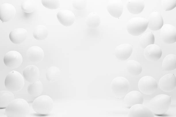 White balloons on white studio background. Birthday party, wedding, anniversary and event celebration backdrop decoration design.