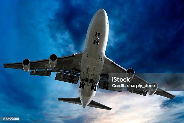 Jumbo Jet Airplane Landing At Dusk Stock Photo - Download Image Now - Above, Aerospace Industry, Air Vehicle