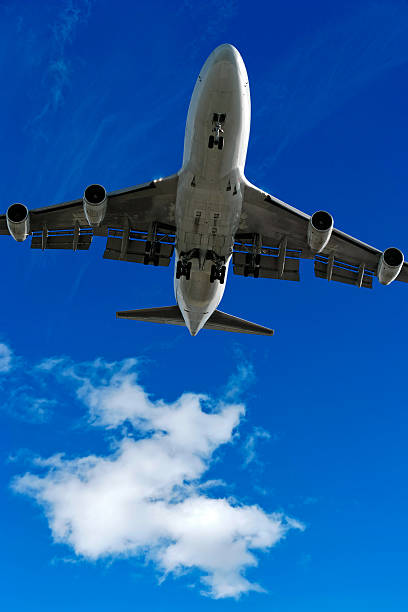 istock jumbo jet airplane landing in bright sky 136899510
