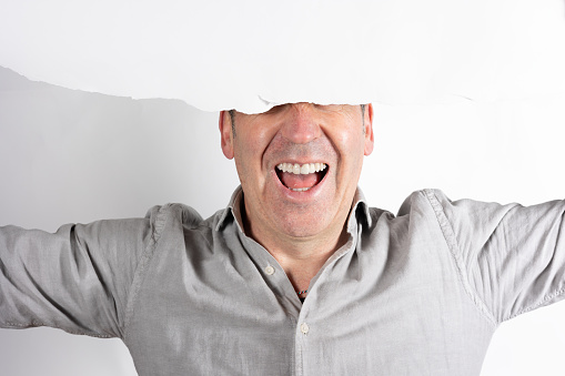 a man with white paper hiding the eyes