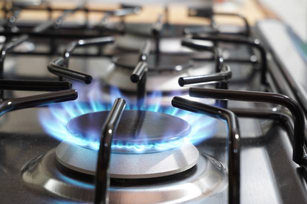 istock Closeup of a black kitchen burner with fire on a stove 1368995895