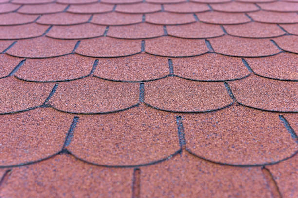 istock Pattern detail of red bitumen shingles on a roof 1368996951