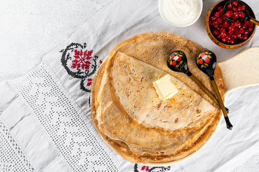 Shrovetide Maslenitsa festival. Russian pancakes blini. Pancakes with honey and jam. Russian spoons. National russian festival. Russian crepes.