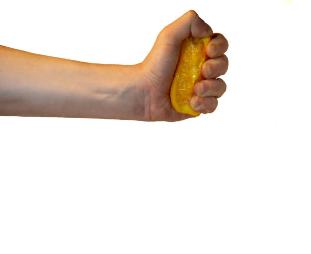 istock Hand pressing a half of an orange 1368997582