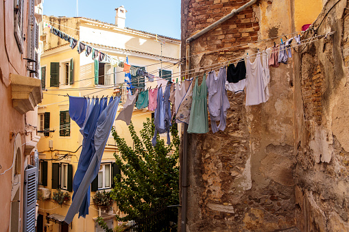 Clothes drying on rope between houses in Corfu Town, Corfu, Greece