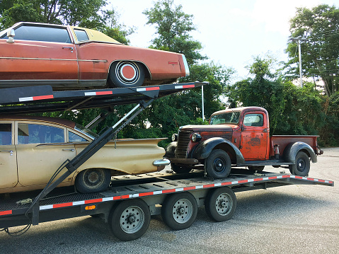 Anitque Automobiles, Vintage Cars and Pickup Truck on a Car Carrier Vehicle