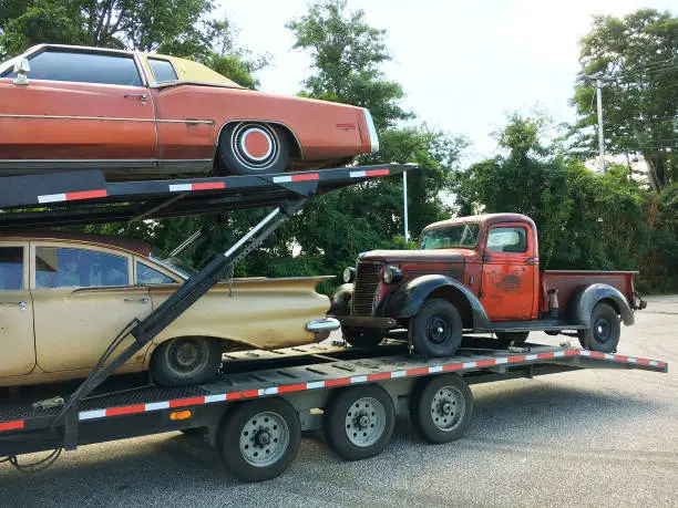 Anitque Automobiles, Vintage Cars and Pickup Truck on a Car Carrier Vehicle
