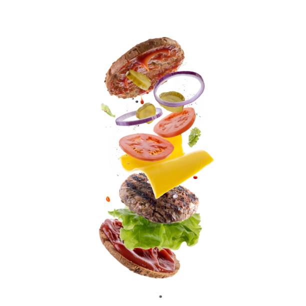 istock Burger with flying elements. Delicious burger with flying ingredients. Flying Burger Slices 1369001149