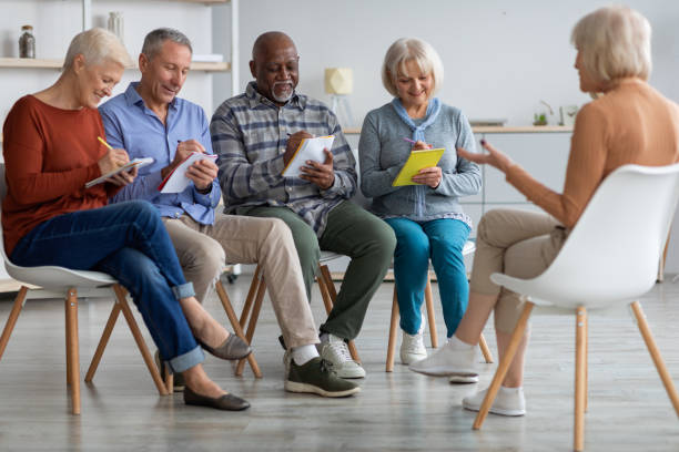 istock Multiracial group of elderly men and women having educational class 1369003733