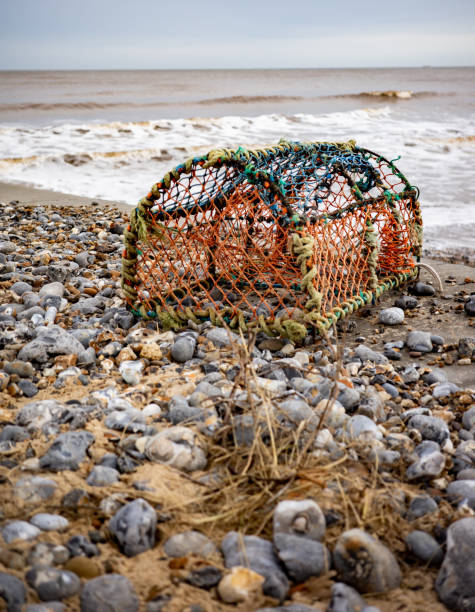 Close and selective focus on a crab pot, lobster pot or fish trap on Cromer beach on the North Norfolk coast