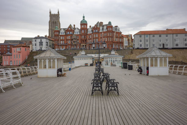 A view along the Victorian Cromer pier towards the seafront and town on a dull and overcast winter's day