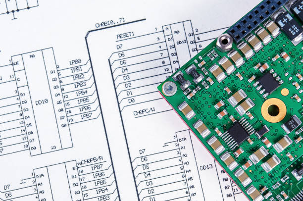 istock Electronic board on background of  schematic circuit diagram. Concept for development and design of electronic devices. 1369006688