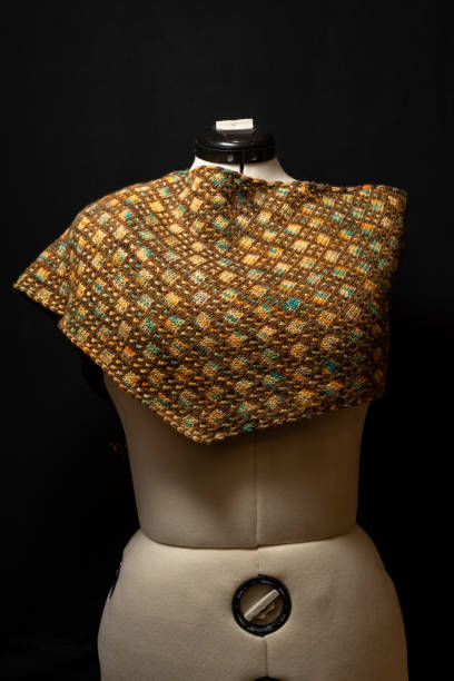istock Handmade shawl crochet on a white mannequin - multicolored yarn. 1369006901