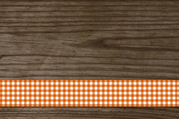Old wooden texture with red and white checkered tablecloth