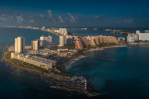 View from a height of the waterfront and the hotel area of ​​Cancun. In the foreground is a Punta Cancun lighthouse and the Hyatt Ziva Cancunt Hotel.